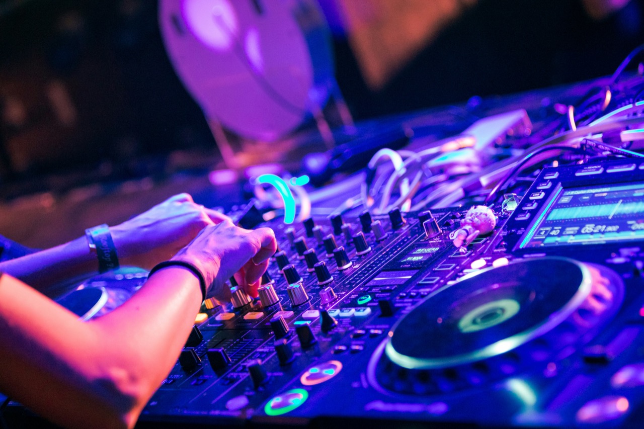 A DJ shaping a set on the decks.