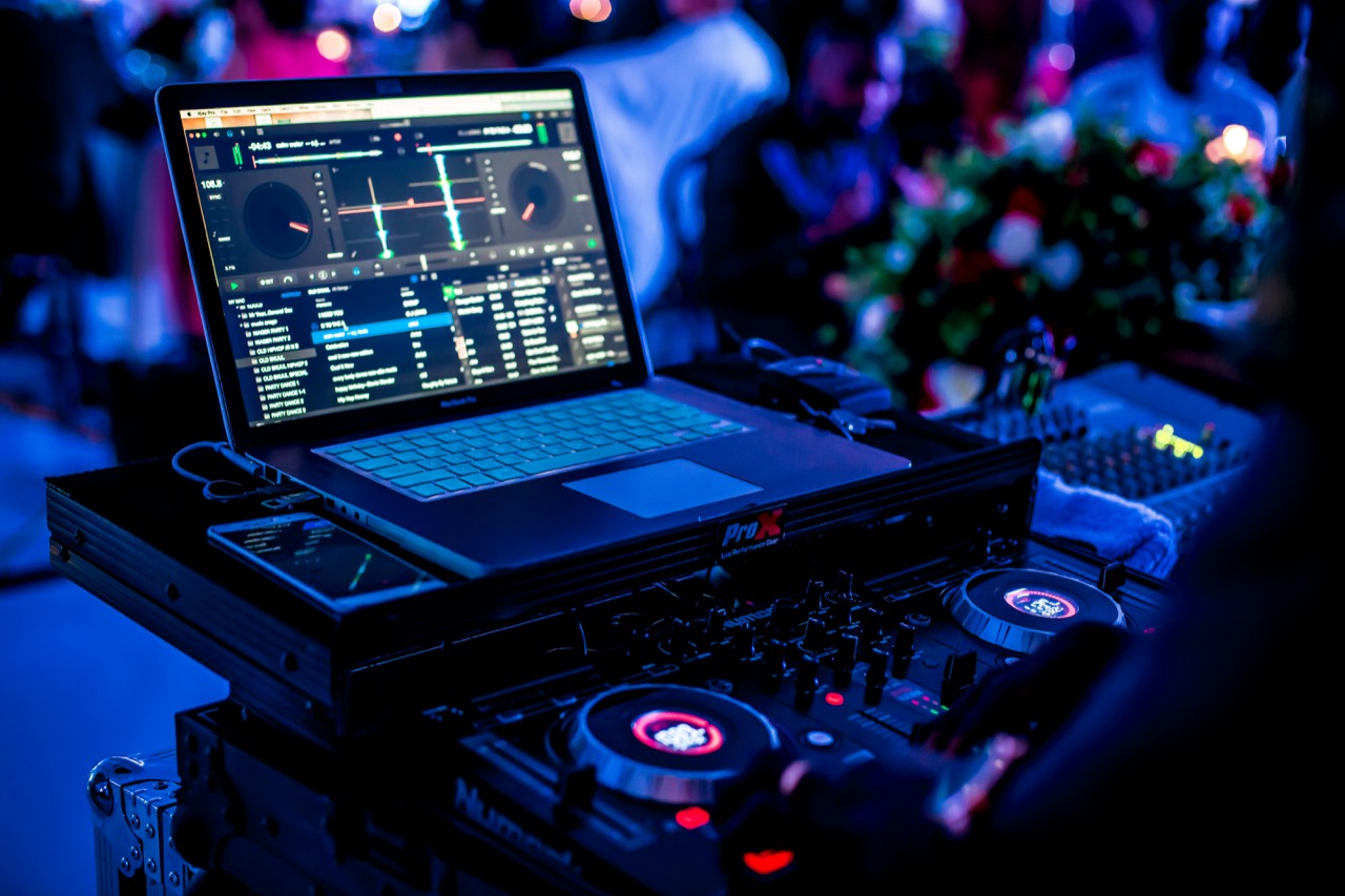 A DJ preparing tracks and planning a set before a performance.